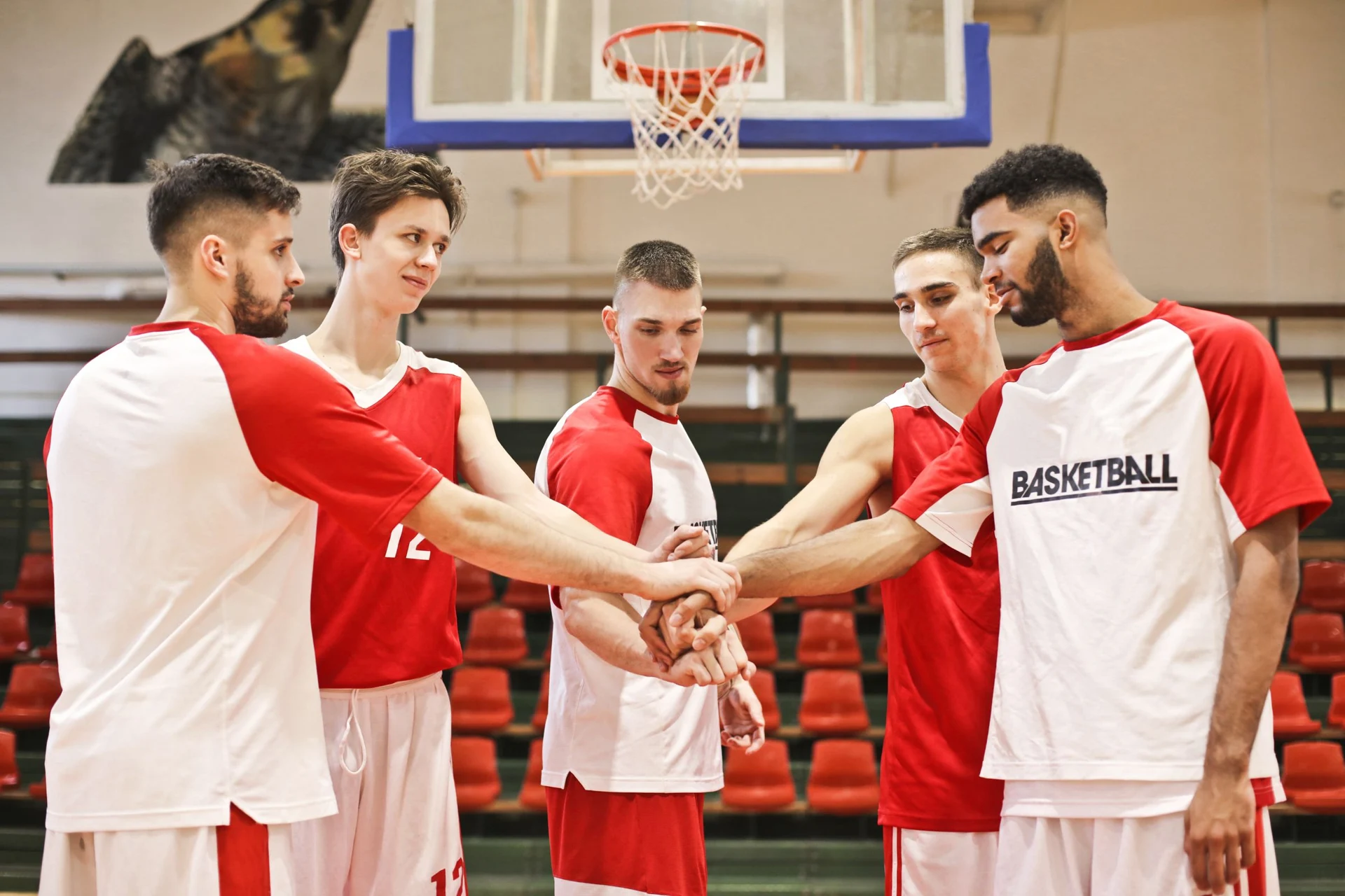 Basketball teammates stacking their hands before a game